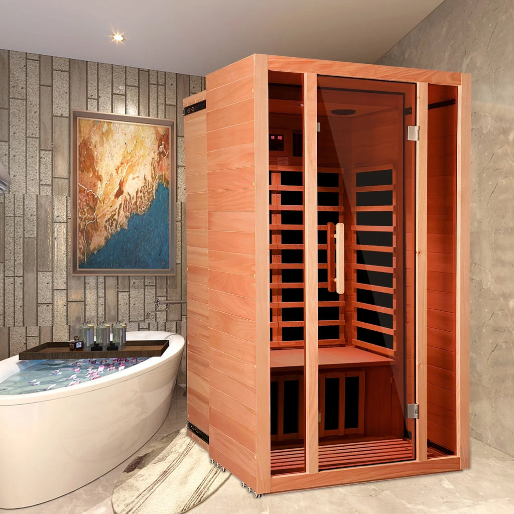 Wooden infrared sauna in a modern bathroom with a bathtub and artwork on the wall.