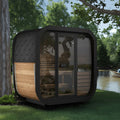 A 3-person luxury cube outdoor sauna near a lake.