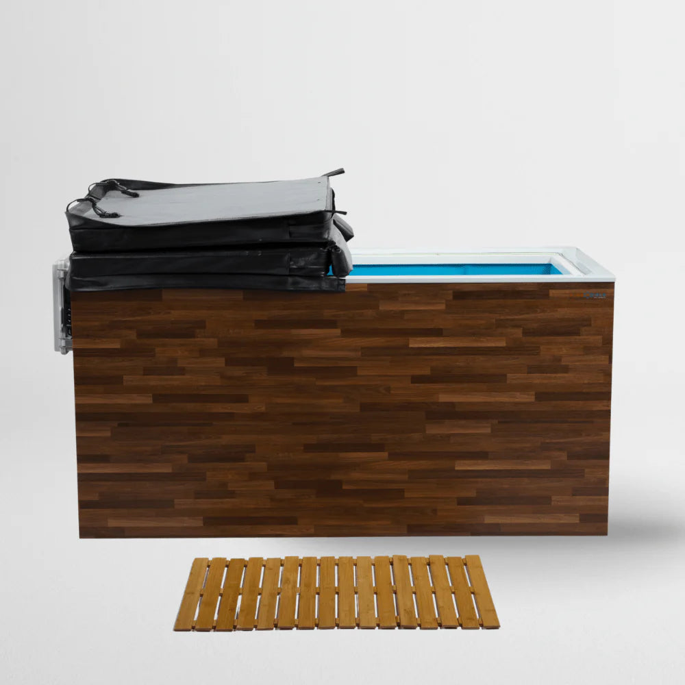 A wooden cold plunge with cover and a blue interior, accompanied by a wooden mat on a white background.
