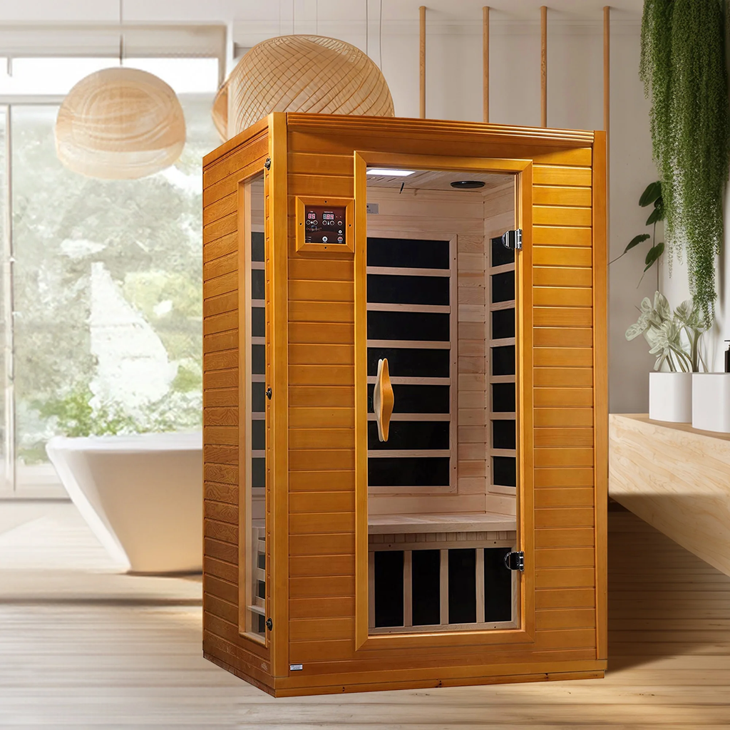 Wooden infrared sauna in a modern bathroom with a bathtub and plants.